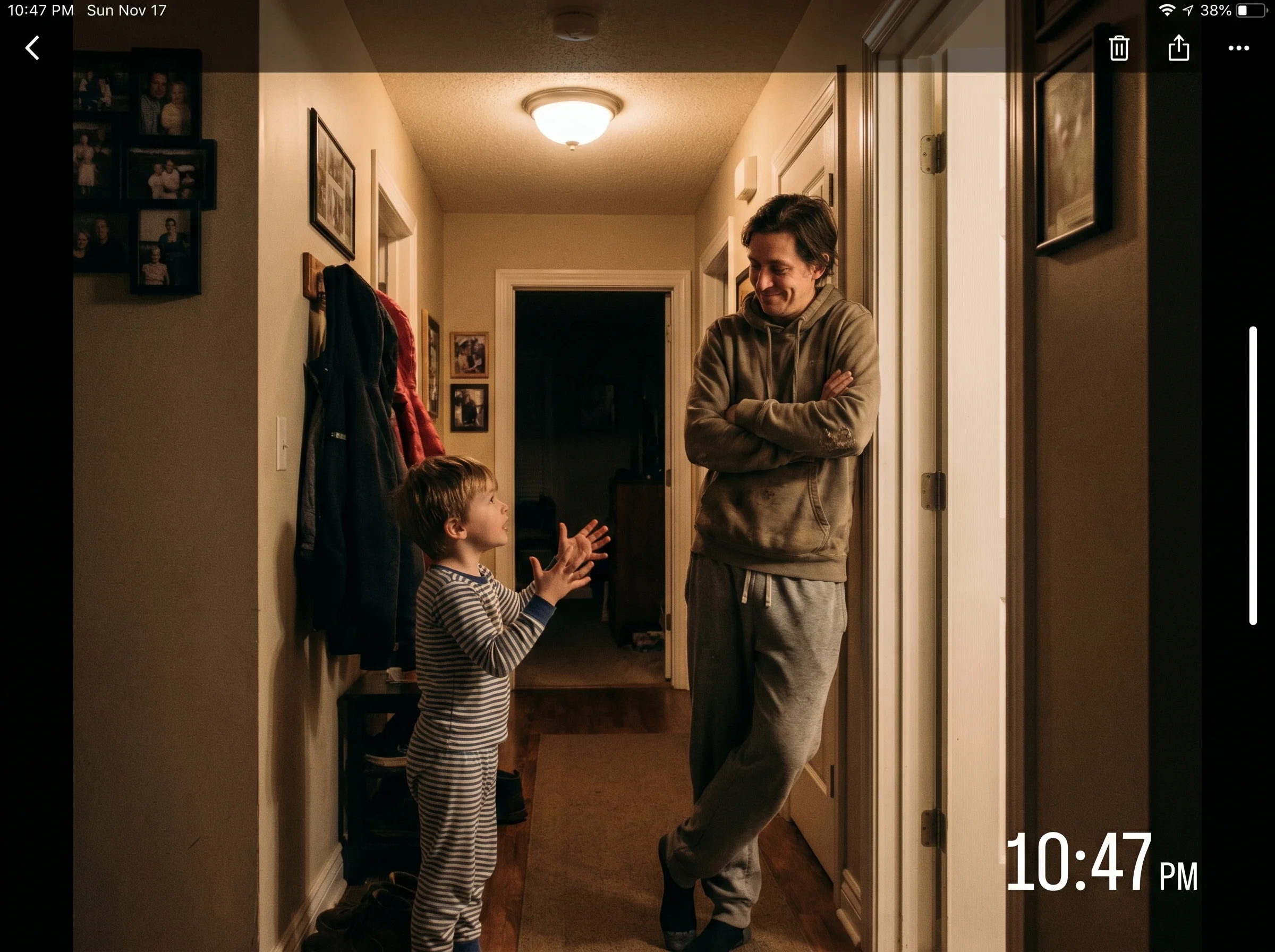 A kid in pajamas standing in a hallway making a serious case to a parent, parent listening with arms crossed and a small smil