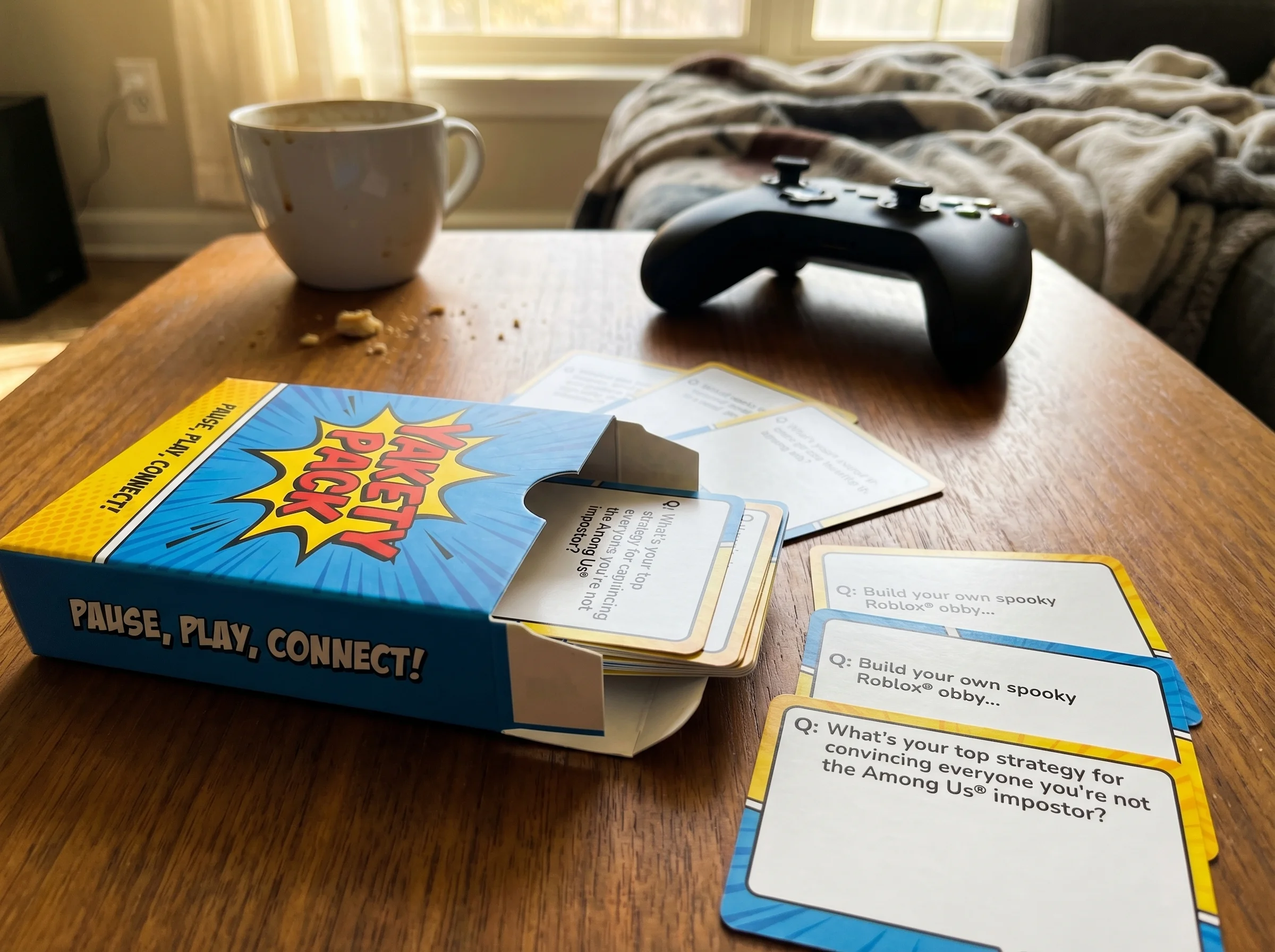 Close-up of game case for Cuphead on coffee table, slightly out of focus controller in background, suggesting abandoned gamep