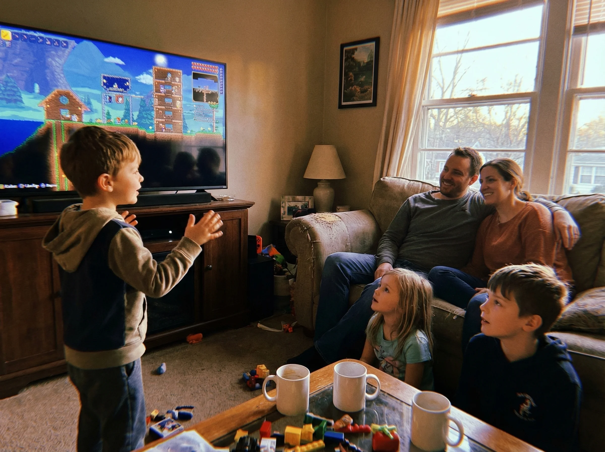 Family gathered around living room TV, kid excitedly showing parents their heavily modded game world while siblings watch wit